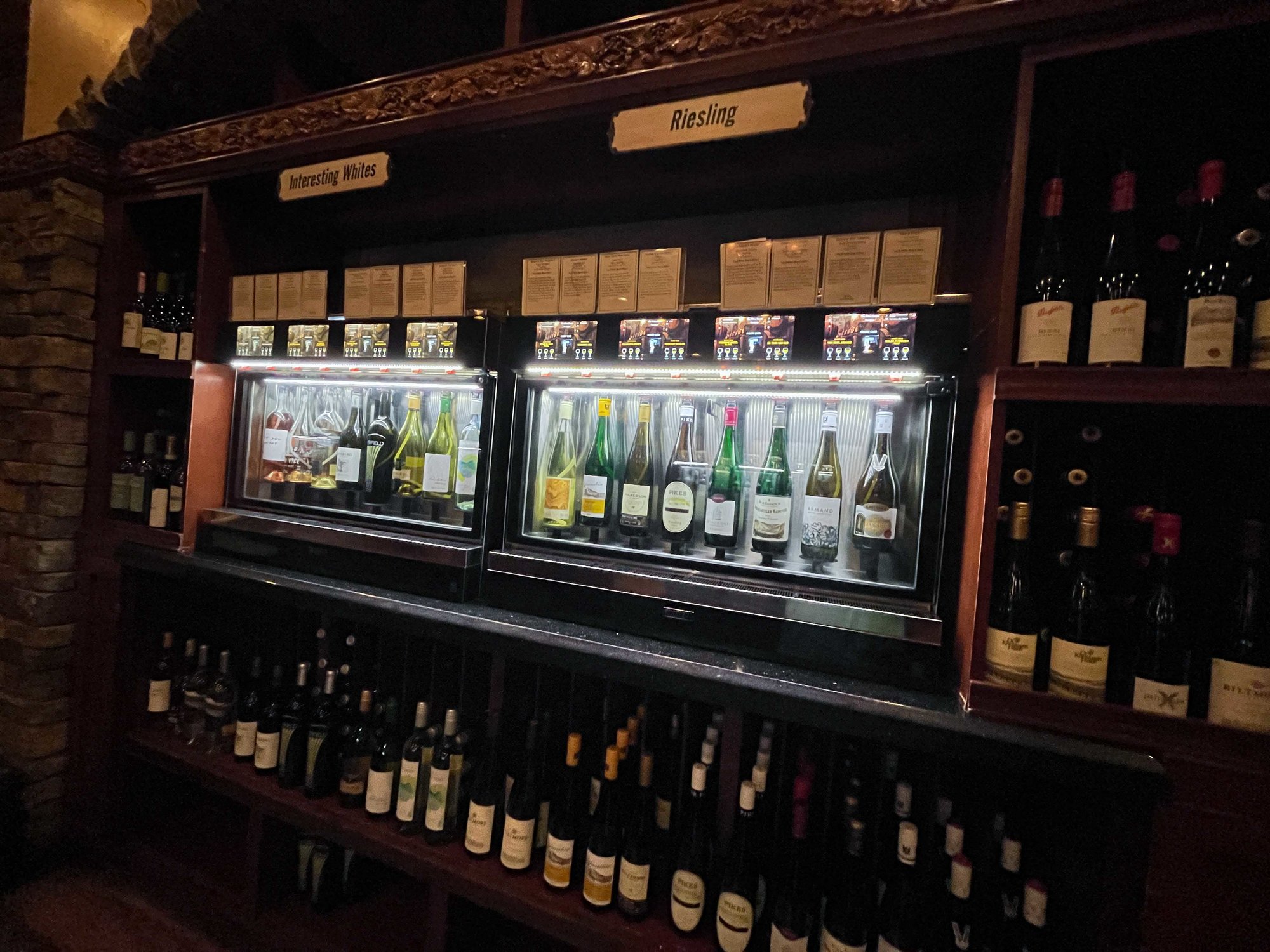 wine bottles in glass wine dispenser case